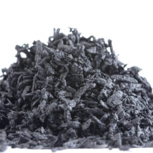 A pile of black shredded paper on top of the floor.