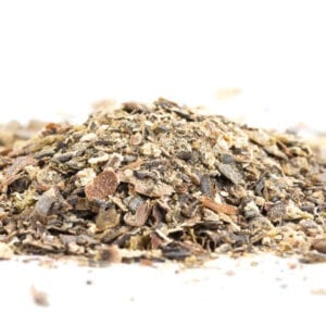 A pile of wood shavings on top of white surface.